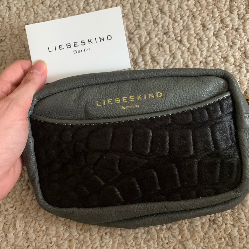 Leather and fur medium size with front pouch. Brand new